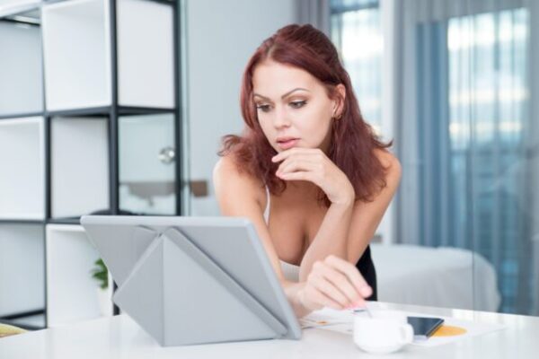 sexy-serious-businesswoman-using-digital-tablet